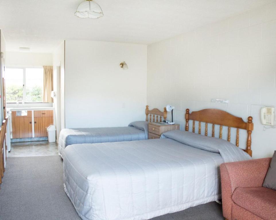 Postel nebo postele na pokoji v ubytování Alpine Motel