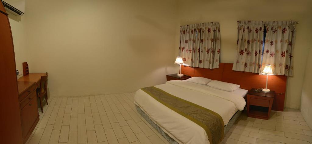 Postel nebo postele na pokoji v ubytování Sabah Tea Resort