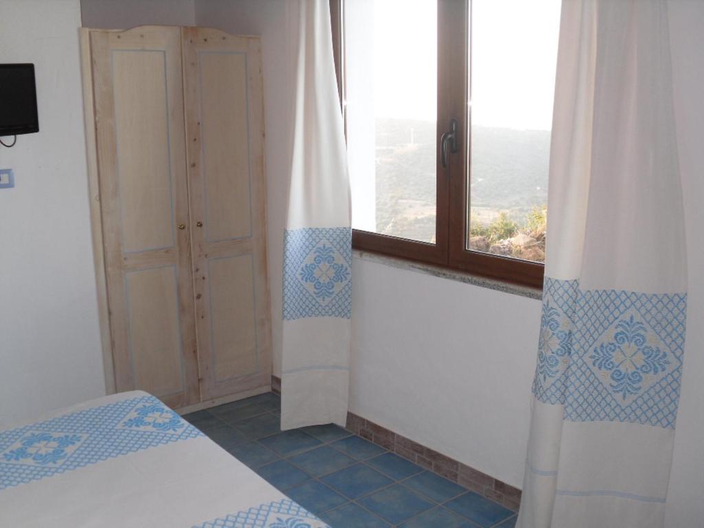 A bed or beds in a room at Agriturismo Irghitula