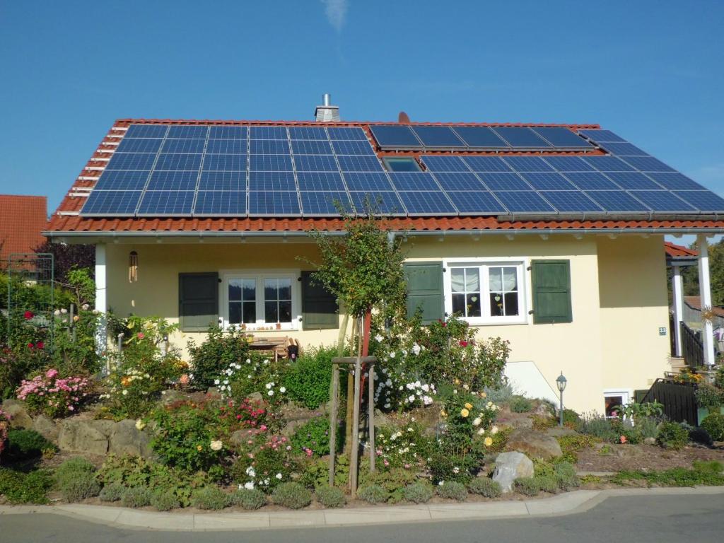 a house with solar panels on the roof at Ferienwohnung Zur Egge in Bad Driburg