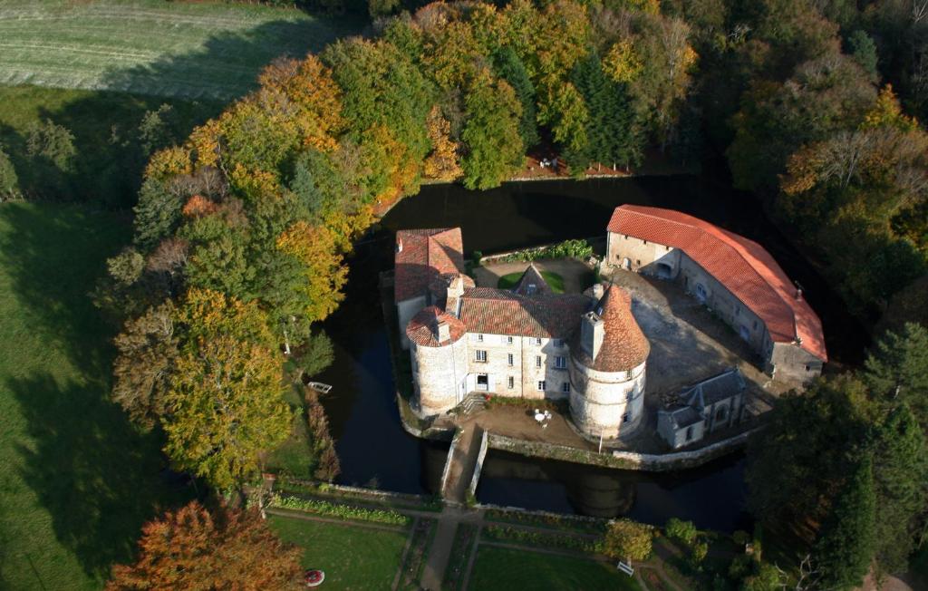 an aerial view of a mansion in the forest at Château des Martinanches in Saint-Dier-dʼAuvergne