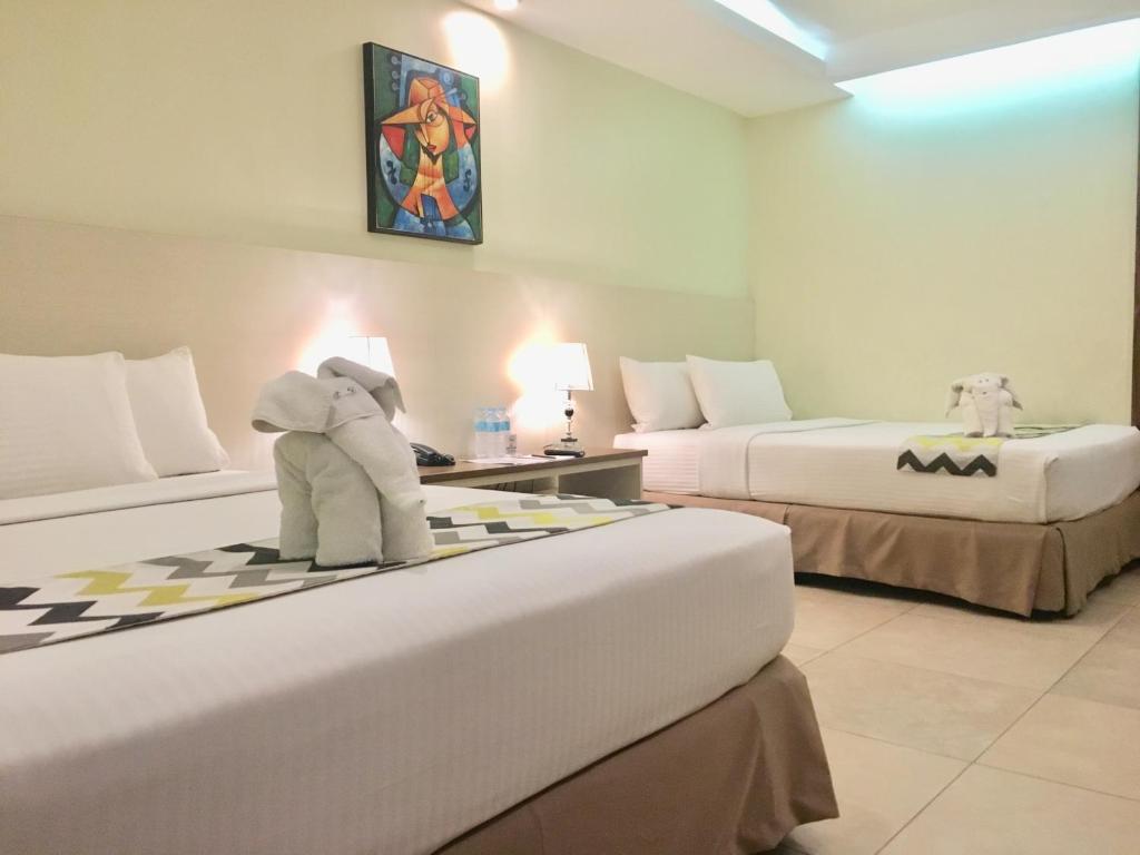 Postel nebo postele na pokoji v ubytování Belian Hotel