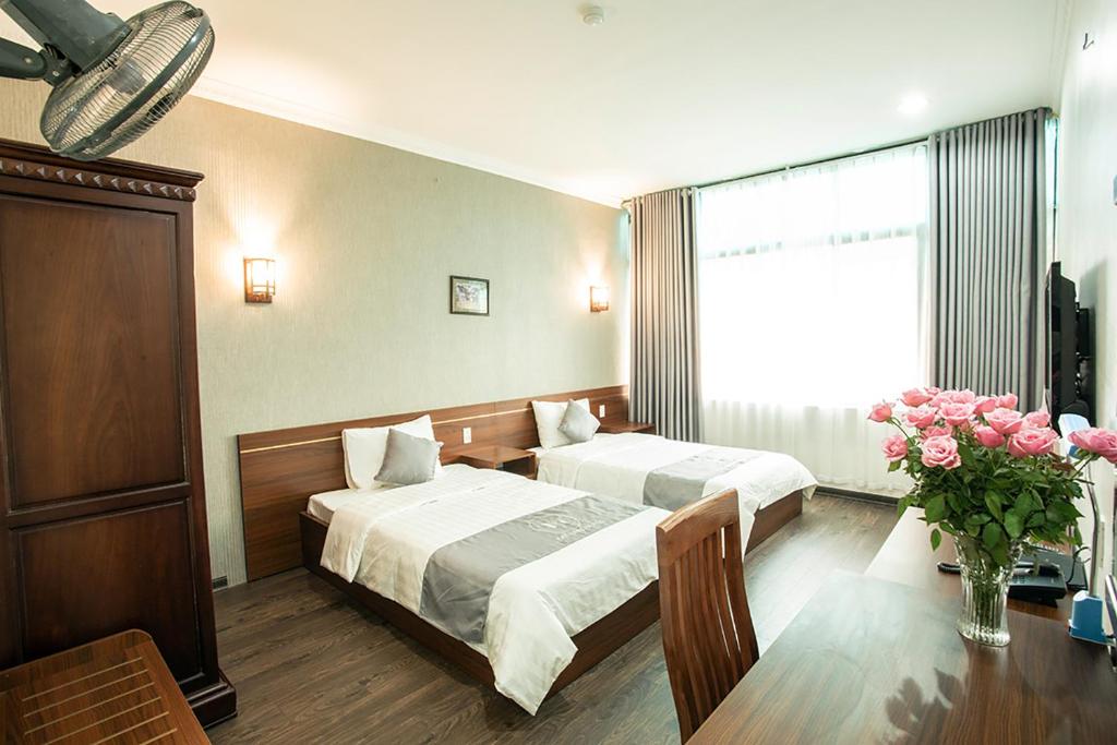 Postel nebo postele na pokoji v ubytování My Lan Hanoi Hotel