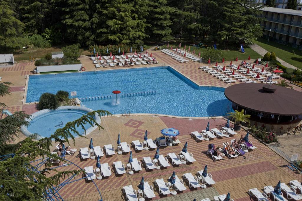 an overhead view of a swimming pool with lounge chairs at Continental Park Hotel in Sunny Beach