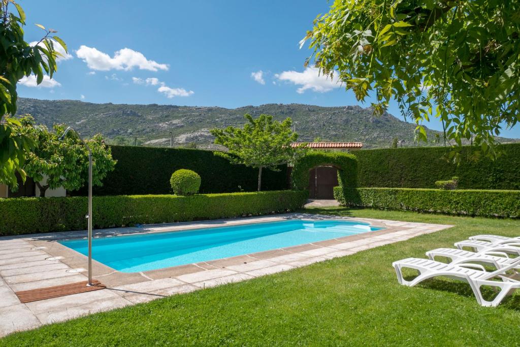 a swimming pool in the yard of a house at Casas Rurales Florentino in Robledillo