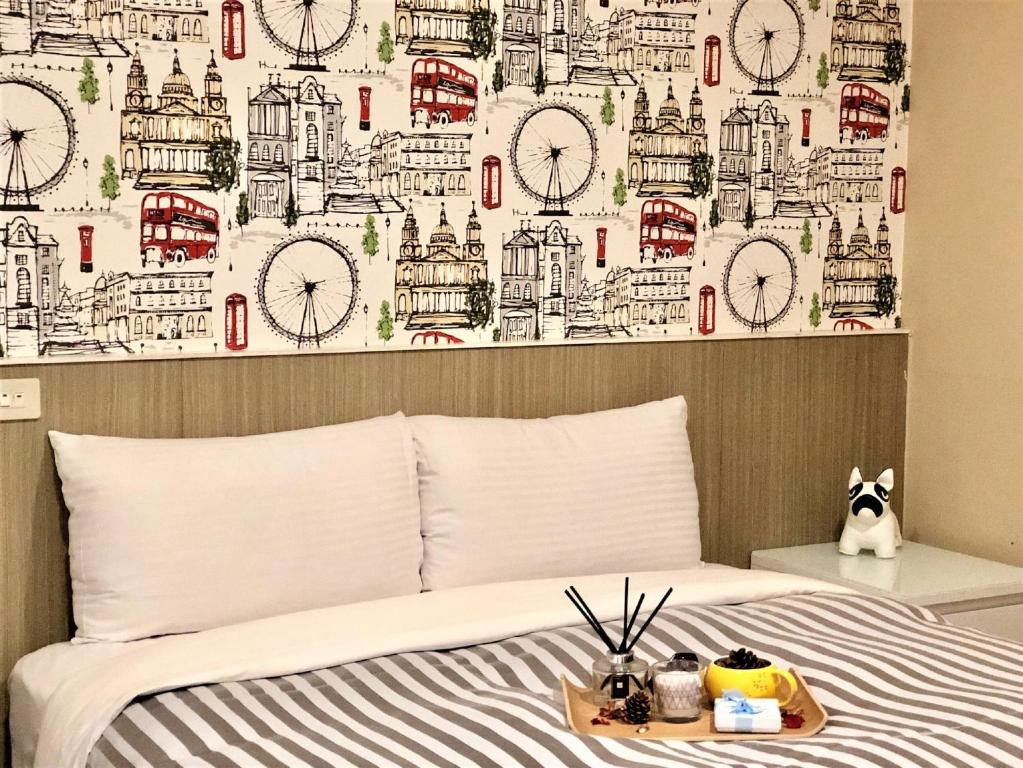 a bedroom with a bed with a wall with clocks at Ximen Hotel in Taipei