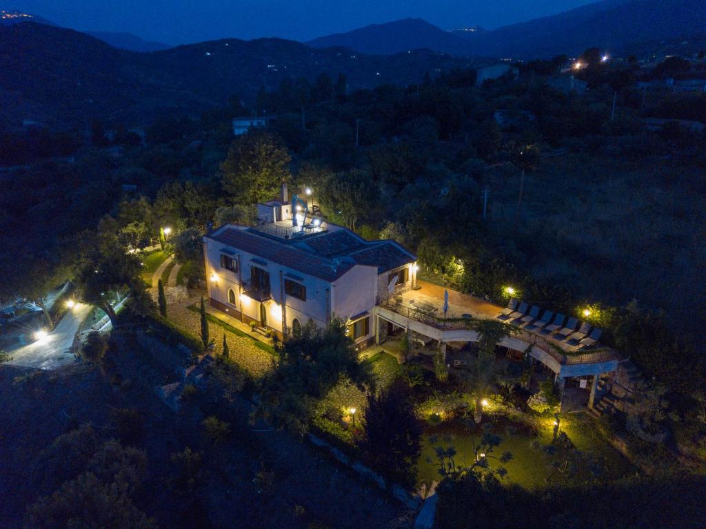 an aerial view of a large house at night at Villarose in Castelbuono
