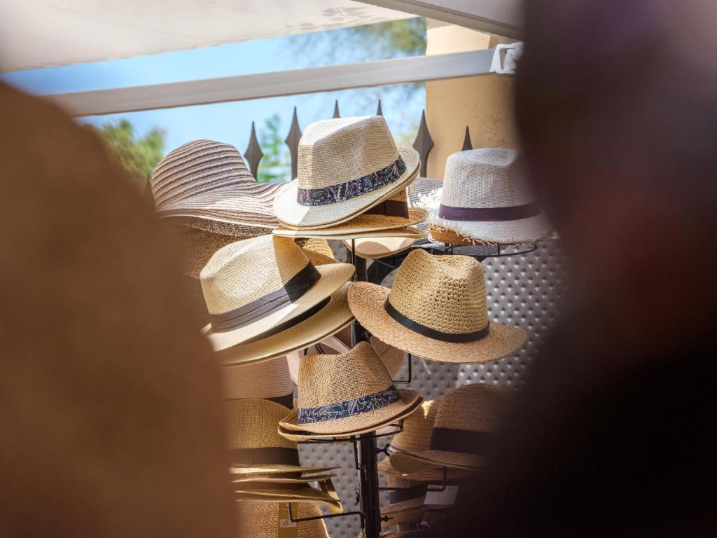 a group of hats hanging on a wall at Hotel Ciutat Jardi in Palma de Mallorca