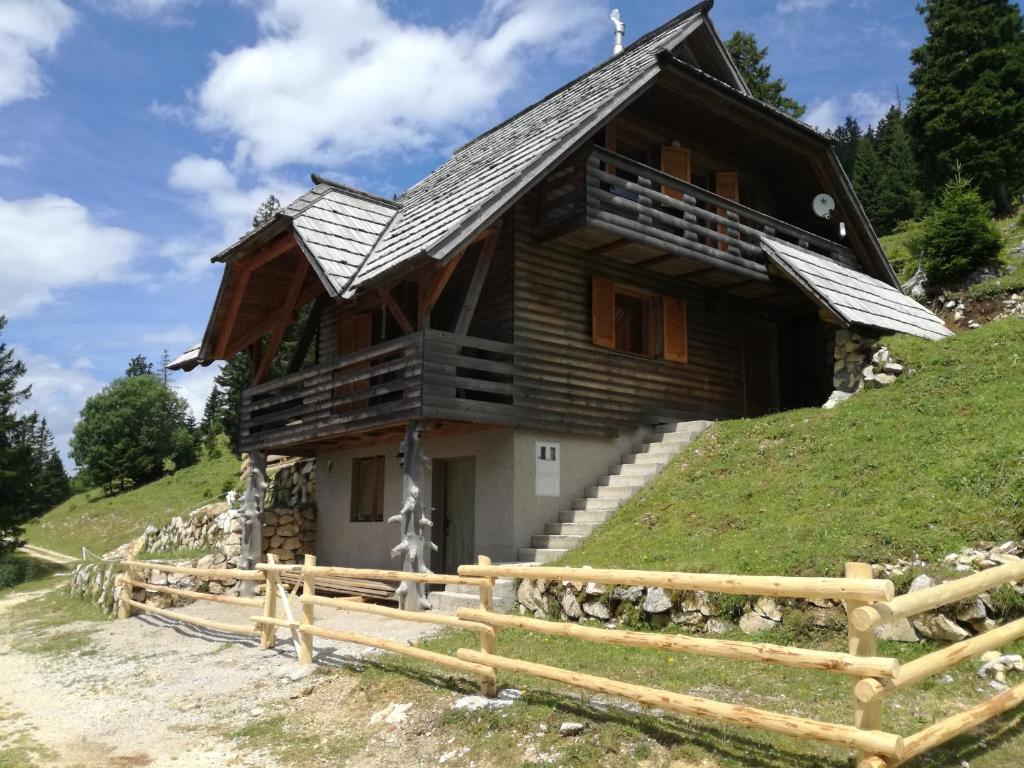 a wooden house on top of a hill at Apartmaji Vrhovnik in Cerklje na Gorenjskem