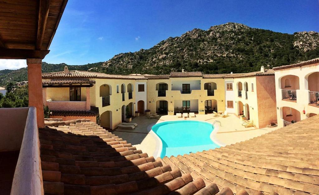 une maison avec une piscine en face de celle-ci dans l'établissement Hotel Monti Di Mola, à Porto Cervo