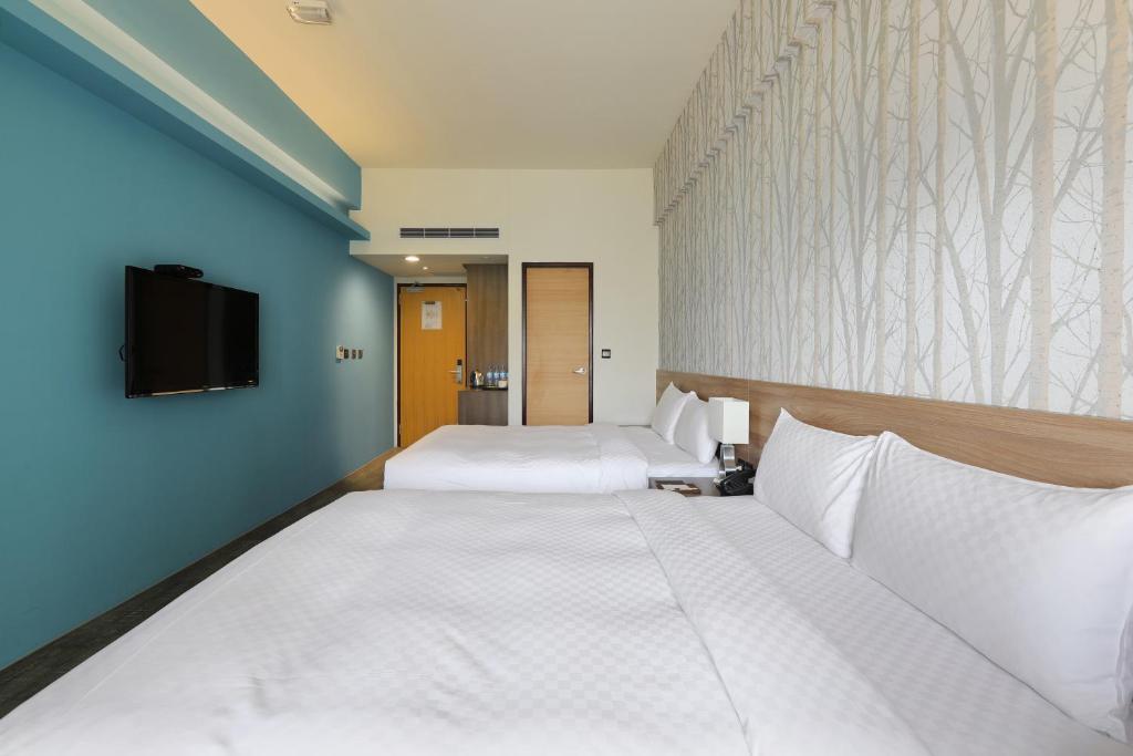 Postel nebo postele na pokoji v ubytování KUN Hotel