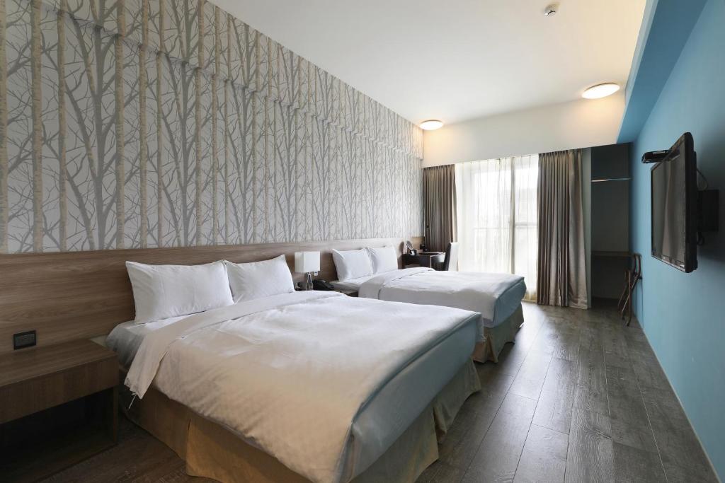 Postel nebo postele na pokoji v ubytování KUN Hotel