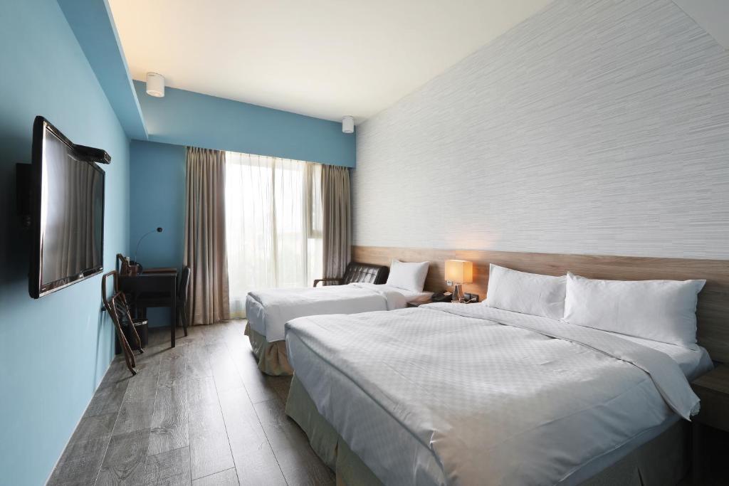 Postel nebo postele na pokoji v ubytování KUN Hotel
