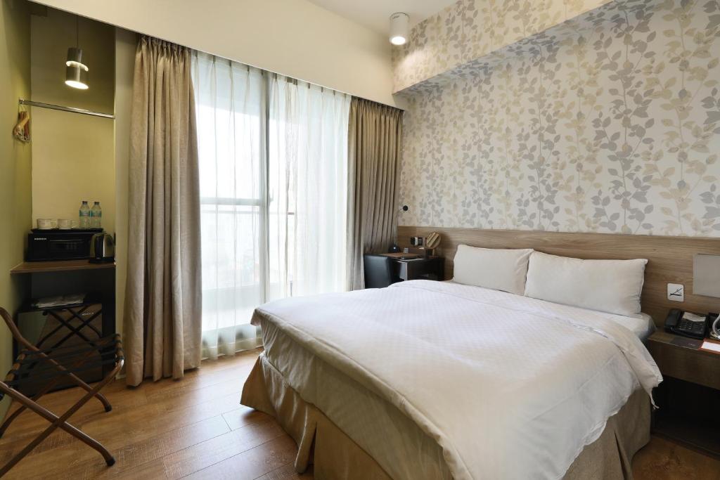 Postel nebo postele na pokoji v ubytování KUN Hotel