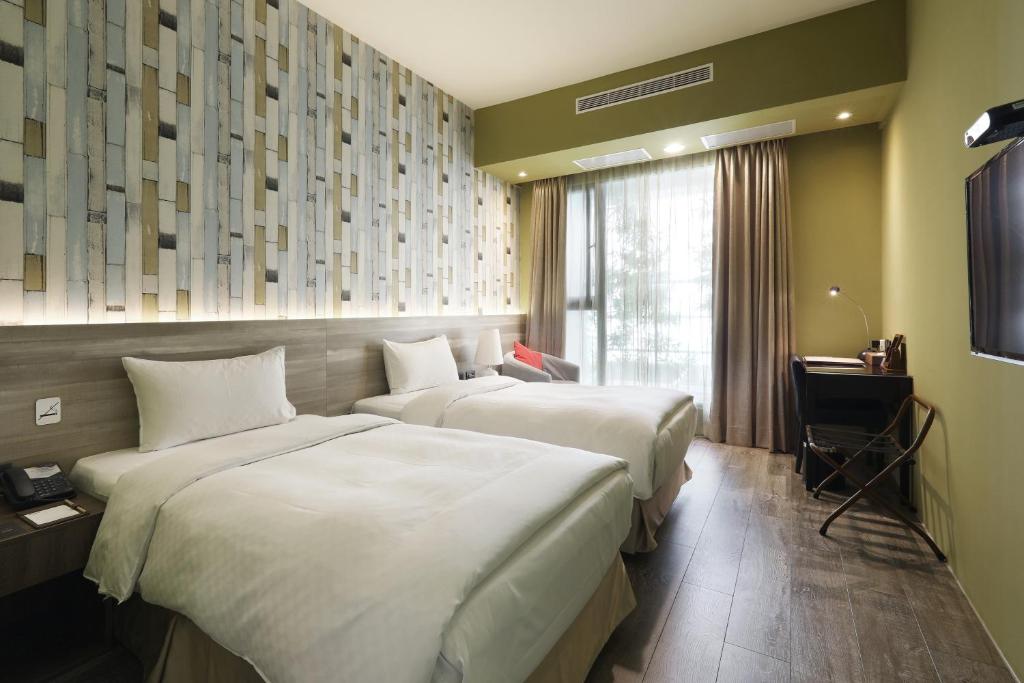 Postel nebo postele na pokoji v ubytování KUN Hotel