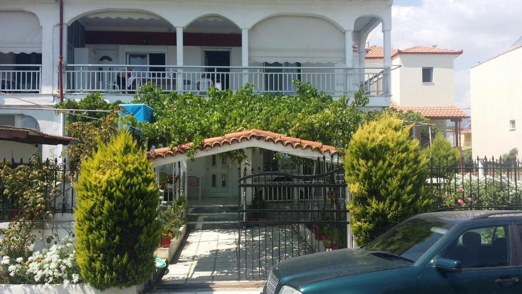 a car parked in front of a house at Grigorios Apartments in Nea Vrasna