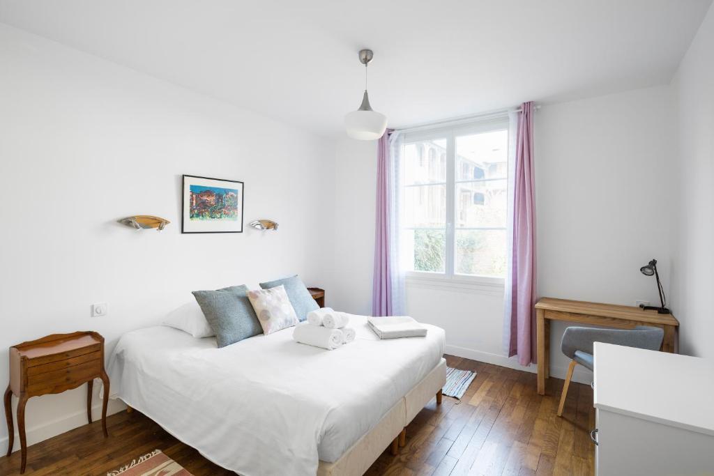 a white bedroom with a bed and a window at Le Meridien by Cocoonr in Rennes