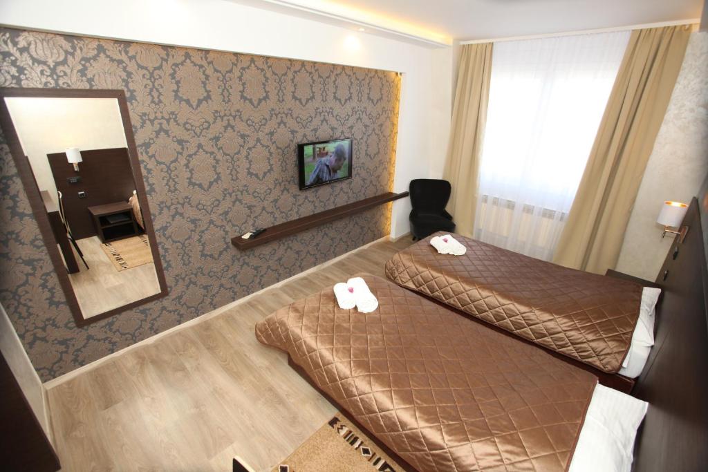 Postel nebo postele na pokoji v ubytování Hotel Petrus