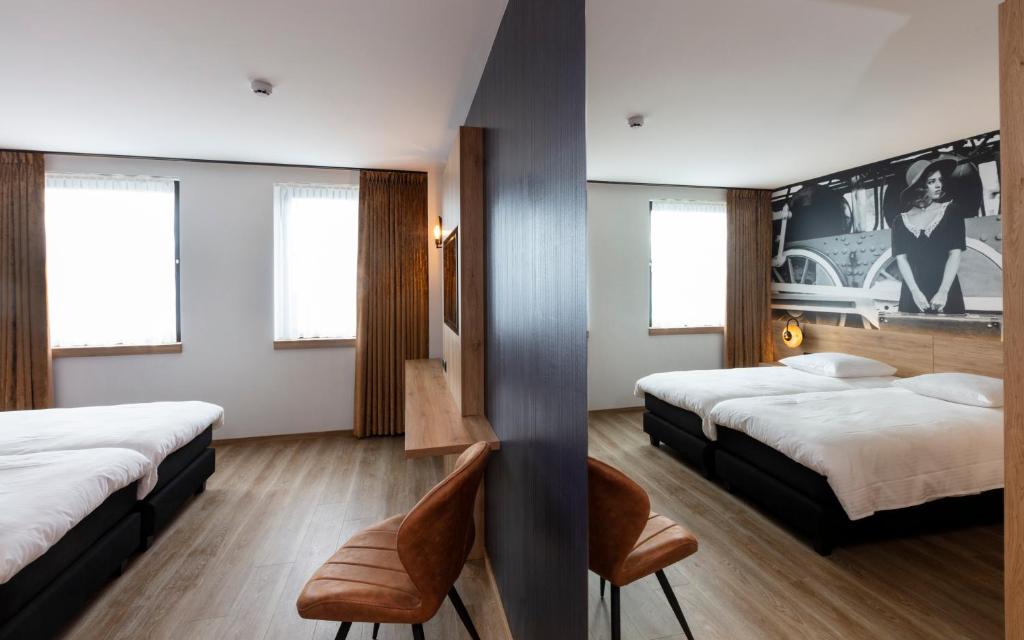 Postel nebo postele na pokoji v ubytování Hotel Leo Station, Villa et Annexes