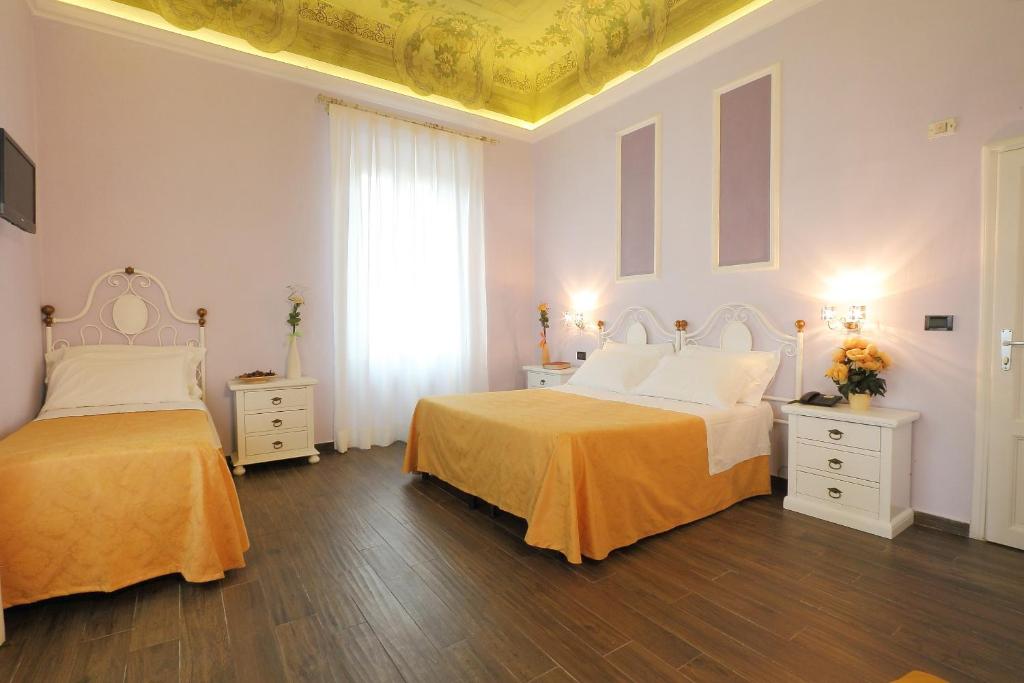 Postel nebo postele na pokoji v ubytování Hotel Ferrucci