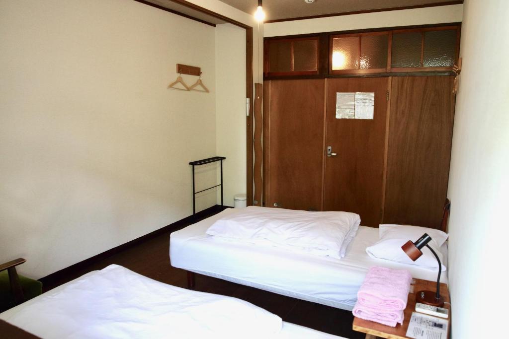 Postel nebo postele na pokoji v ubytování Yuzan Guesthouse