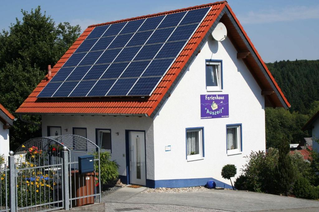 a house with solar panels on the roof at Ferienhaus Auszeit in Waldsolms