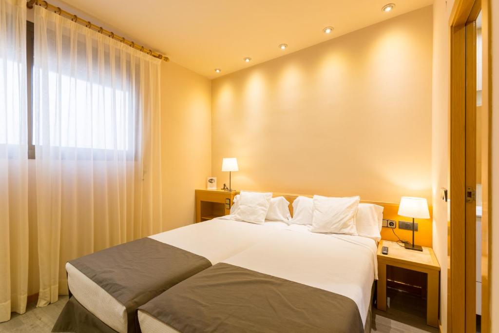 Postel nebo postele na pokoji v ubytování Apartamentos DV
