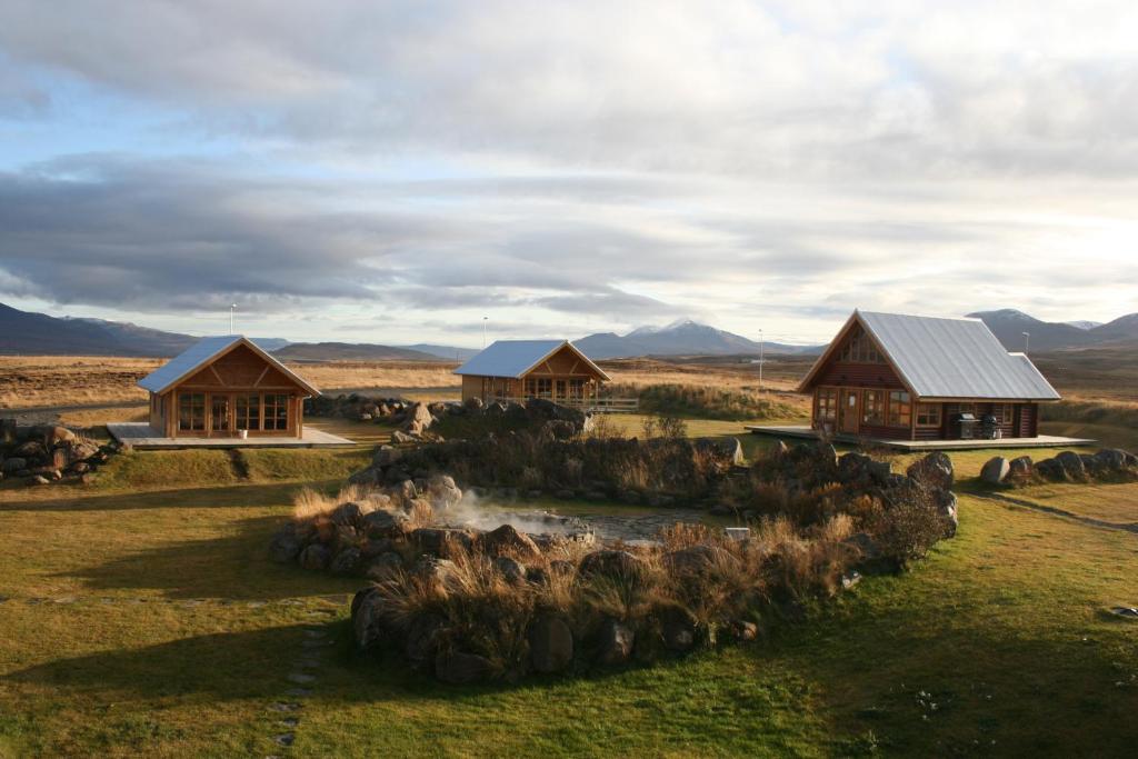 a group of cottages in the middle of a field at Hestasport Cottages in Varmahlid
