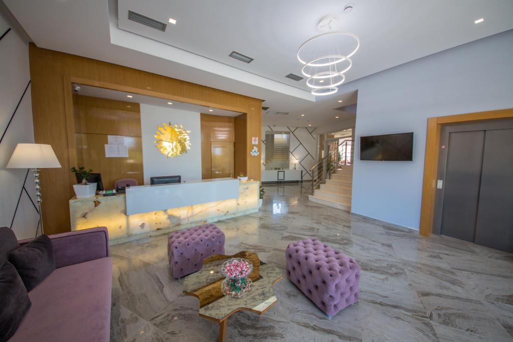 a lobby with purple chairs and a table in a building at Sole Luna Hotel in Borsh