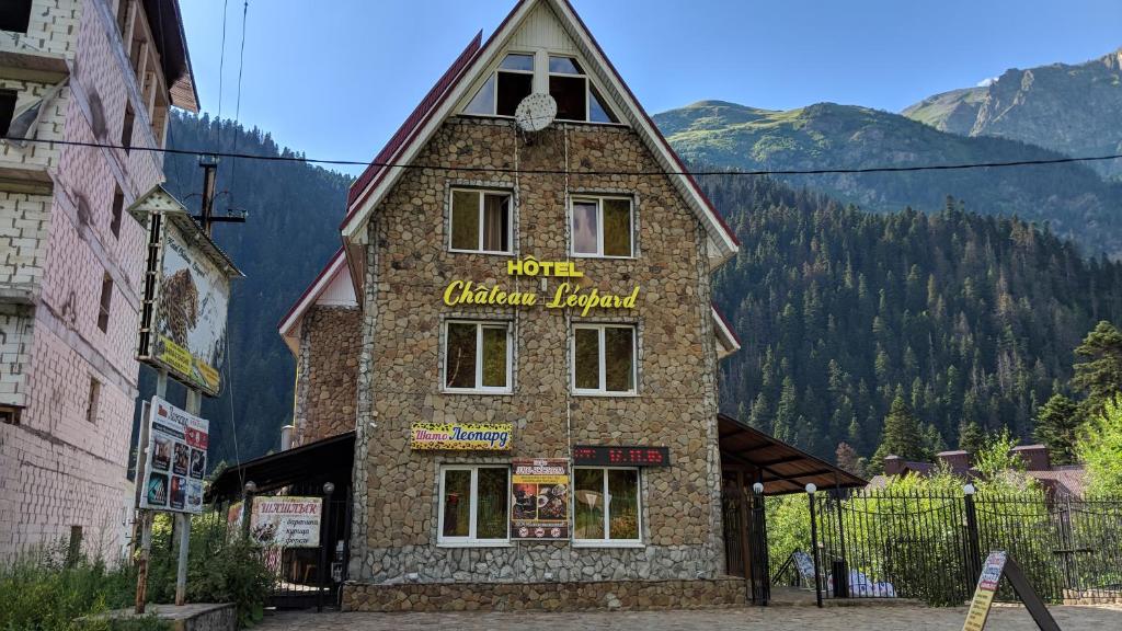 a building with a sign on the side of it at Shato Leopard in Dombay