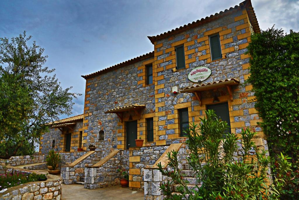 a large stone building with a sign on it at Kardamili Villas in Kardamyli