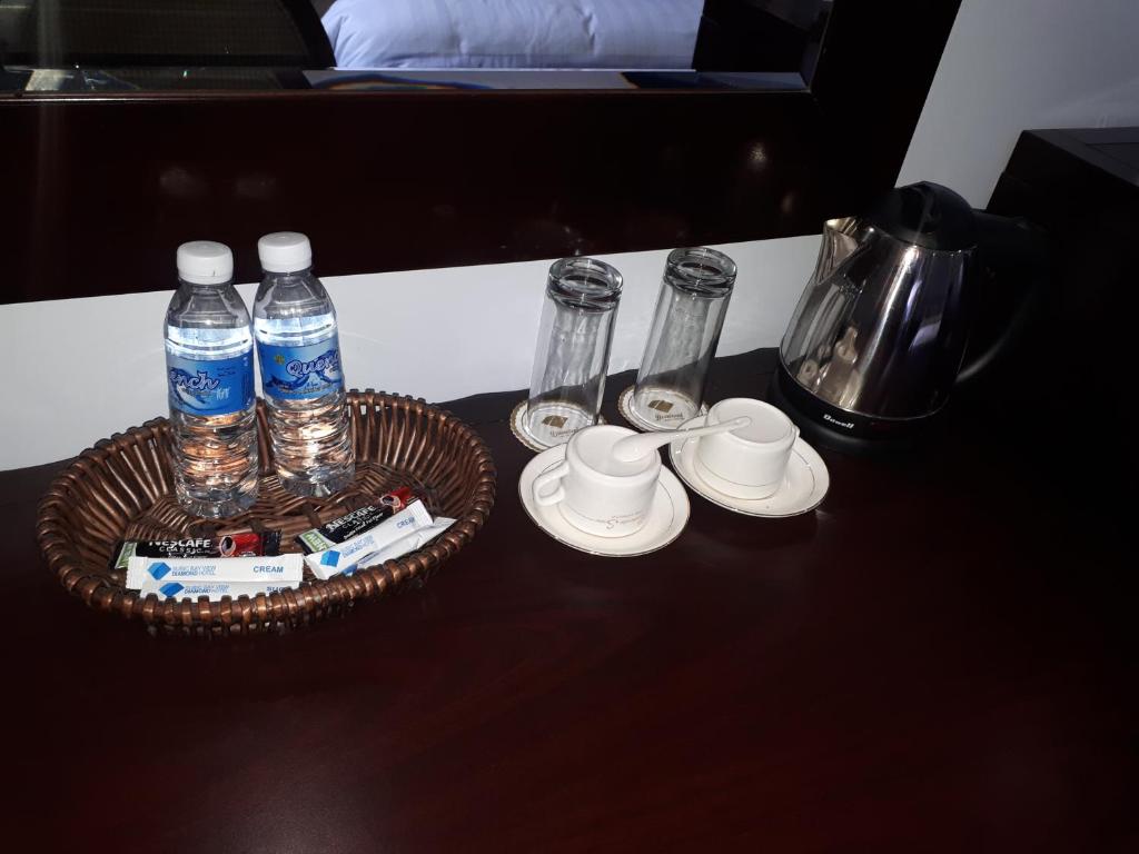 a table with a tray of water bottles and cups at Subic Bay View Diamond Hotel in Olongapo