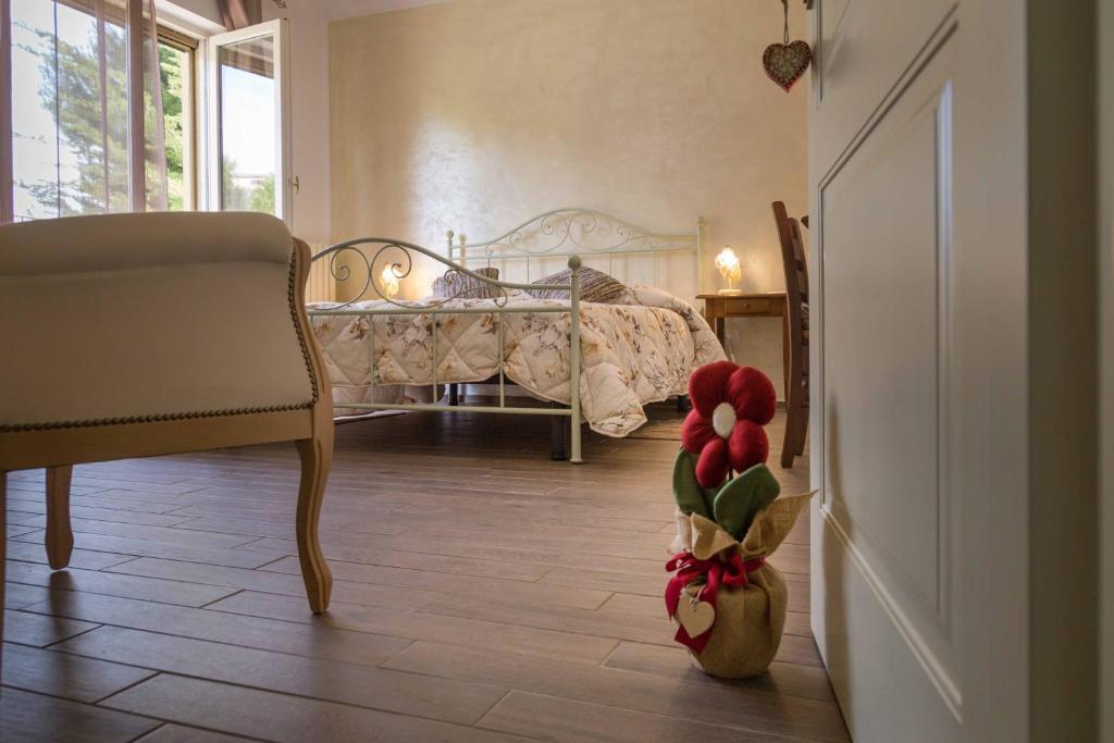 a bedroom with a bed and a vase with tulips in it at FELICITA B&B in Acquaviva Picena