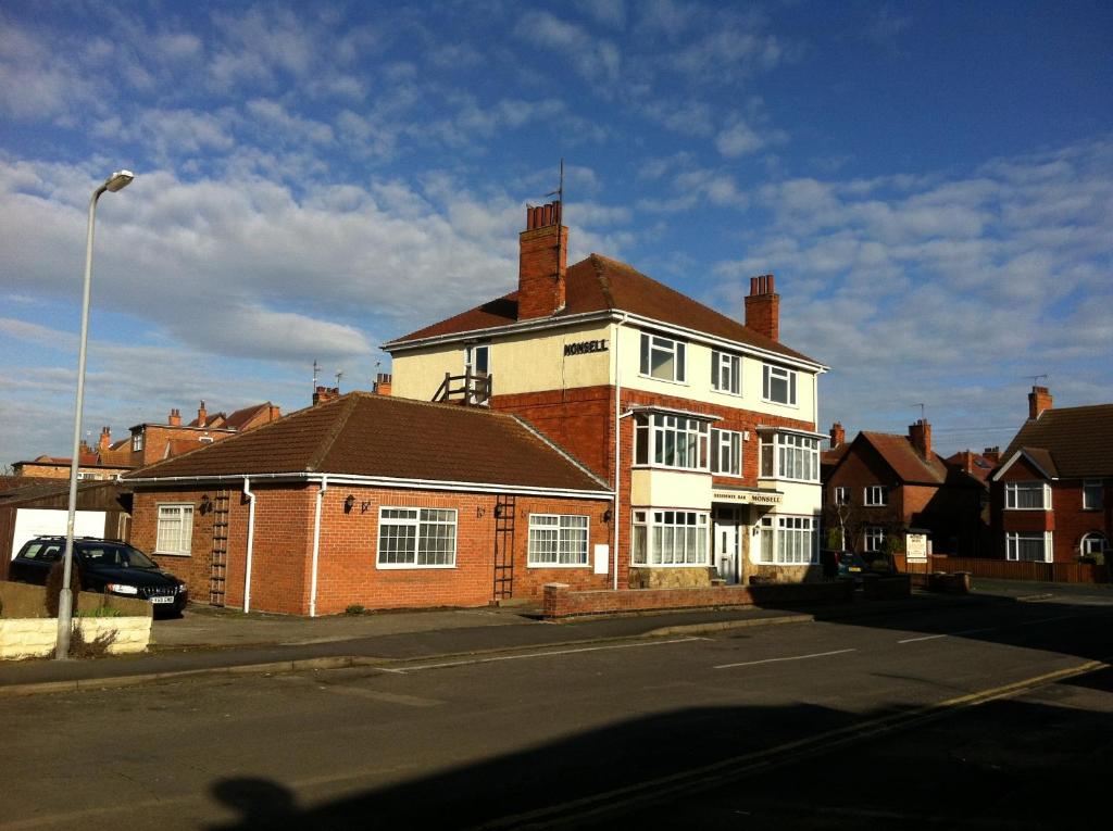 a large brick house on the corner of a street at The Monsell Hotel in Skegness