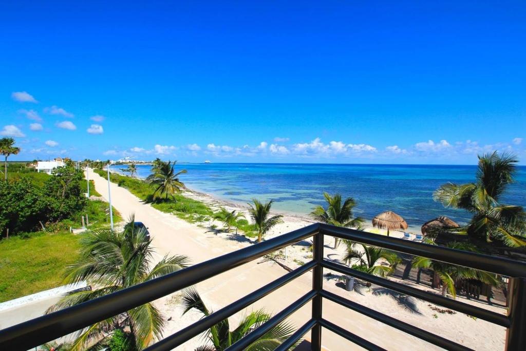 a view of the beach from a balcony at Hotel Arrecifes Costamaya in Mahahual