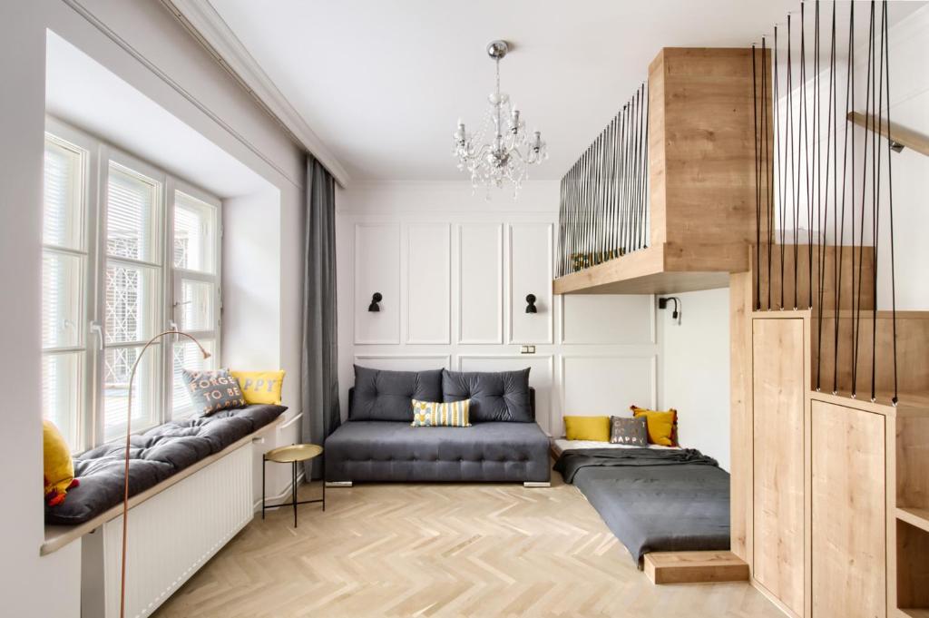 uma sala de estar com um sofá e uma escada em Marta Old Town Apartment em Varósvia