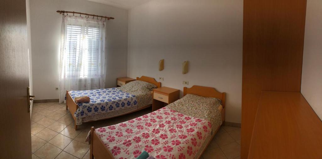 Postel nebo postele na pokoji v ubytování Apartments Bodi
