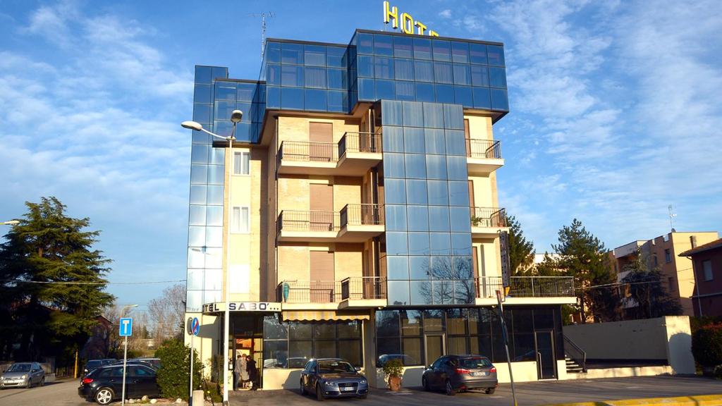 un edificio con coches estacionados frente a él en Hotel Sabo', en Castel Maggiore