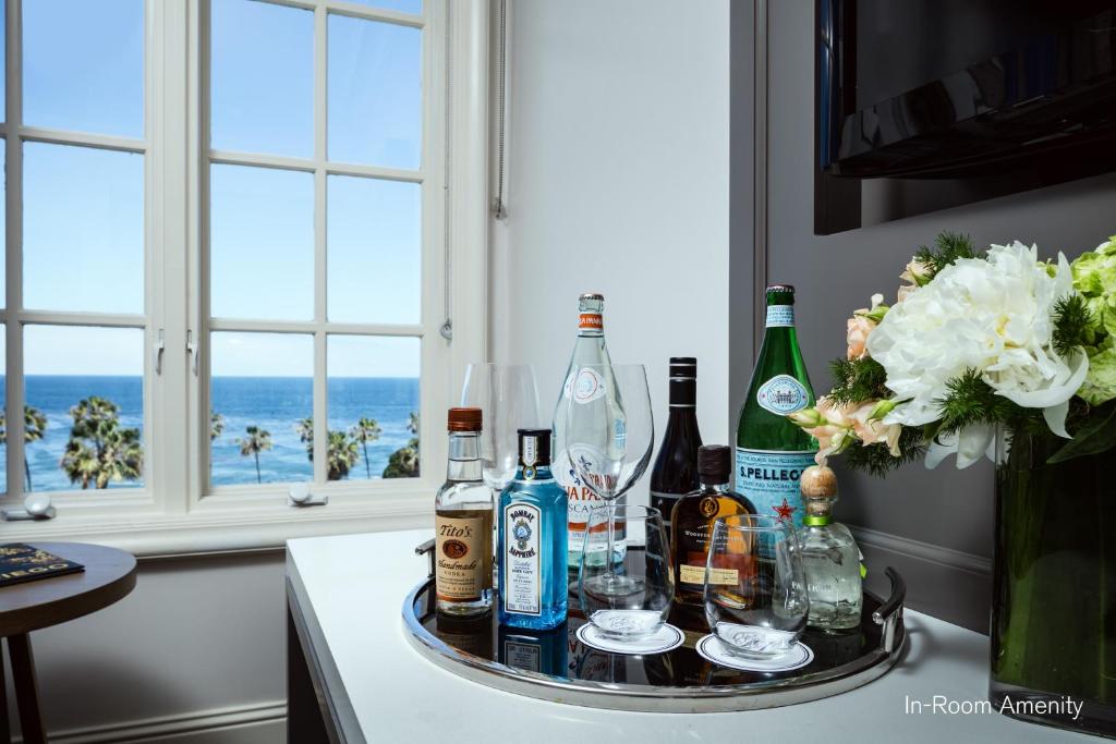 a tray with bottles and glasses on a table at La Valencia Hotel in San Diego