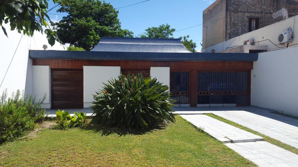 a house with wooden doors and a yard at La Maison in San Fernando del Valle de Catamarca