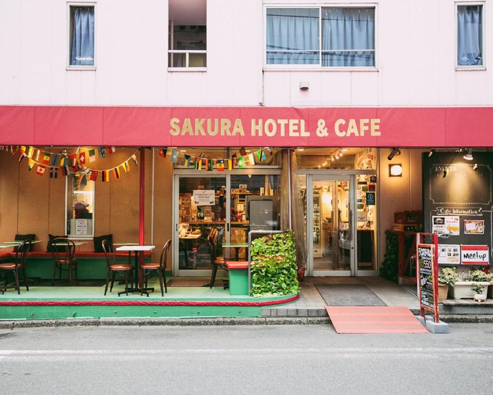 a restaurant with tables and chairs outside of a building at Sakura Hotel Jimbocho in Tokyo