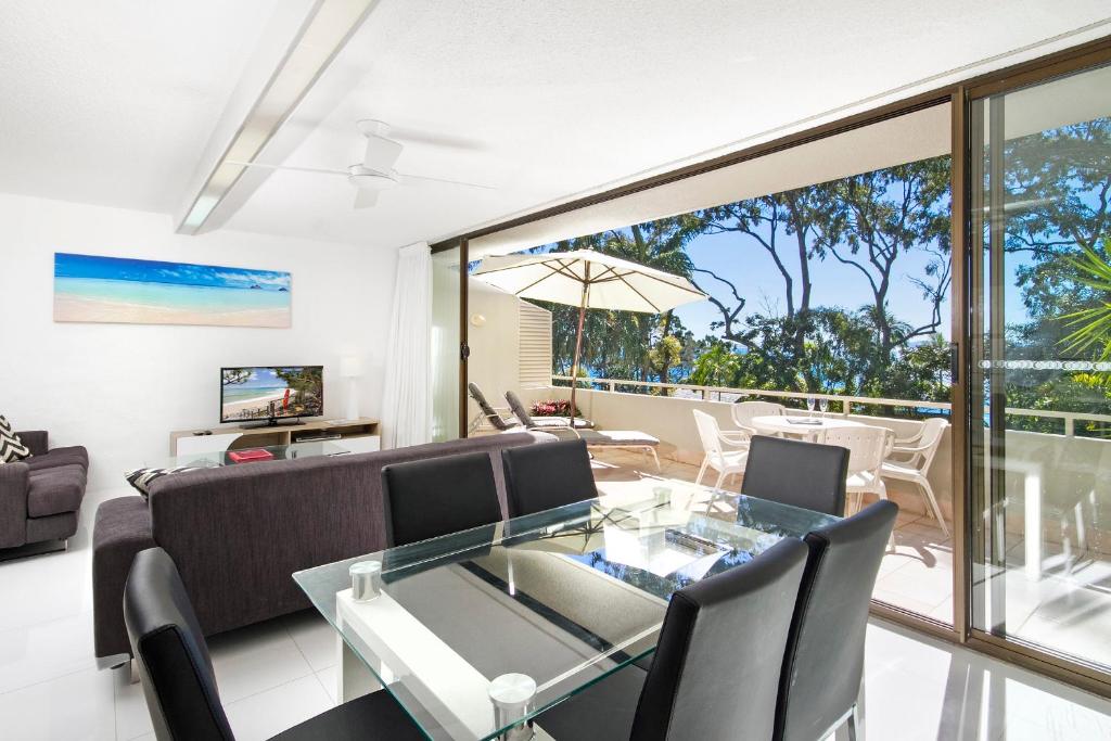 a living room with a glass table and a couch at Cove Point Apartment 2, Little Cove in Noosa Heads