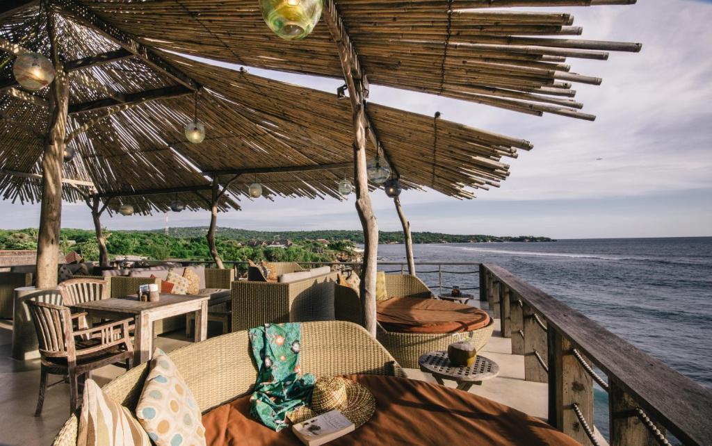 a restaurant with chairs and tables and a view of the ocean at Dream Beach Huts in Nusa Lembongan