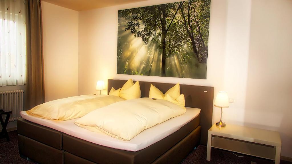 Bett in einem Zimmer mit Wandgemälde in der Unterkunft Fritz Hotel & Restaurant KG in Weil am Rhein