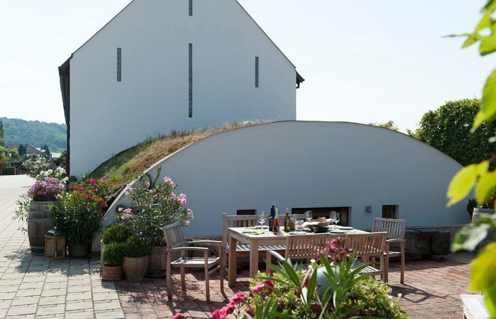 a table and chairs in a patio with a building at Remushof Jagschitz in Oslip