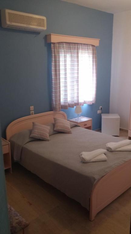 Postel nebo postele na pokoji v ubytování Ifigenia Hotel