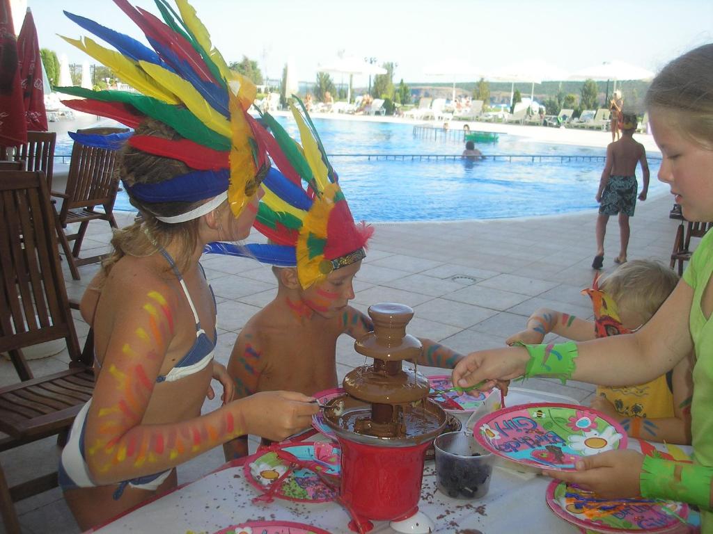 a group of children sitting at a table at a party at Apart Hotel Apolonia Palace in Sinemorets