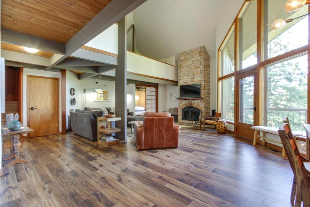 a living room with wood floors and a fireplace at RiverPoint Retreat in Sandpoint