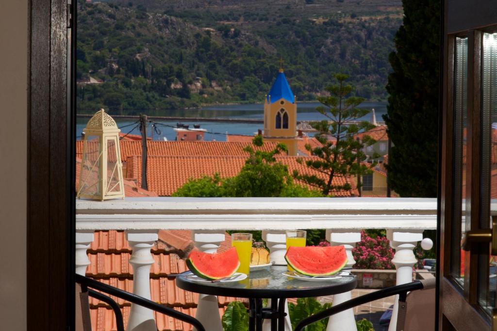 a table with three slices of watermelon on a balcony at Kefalos Quiet Apartment In Argostoli in Argostoli