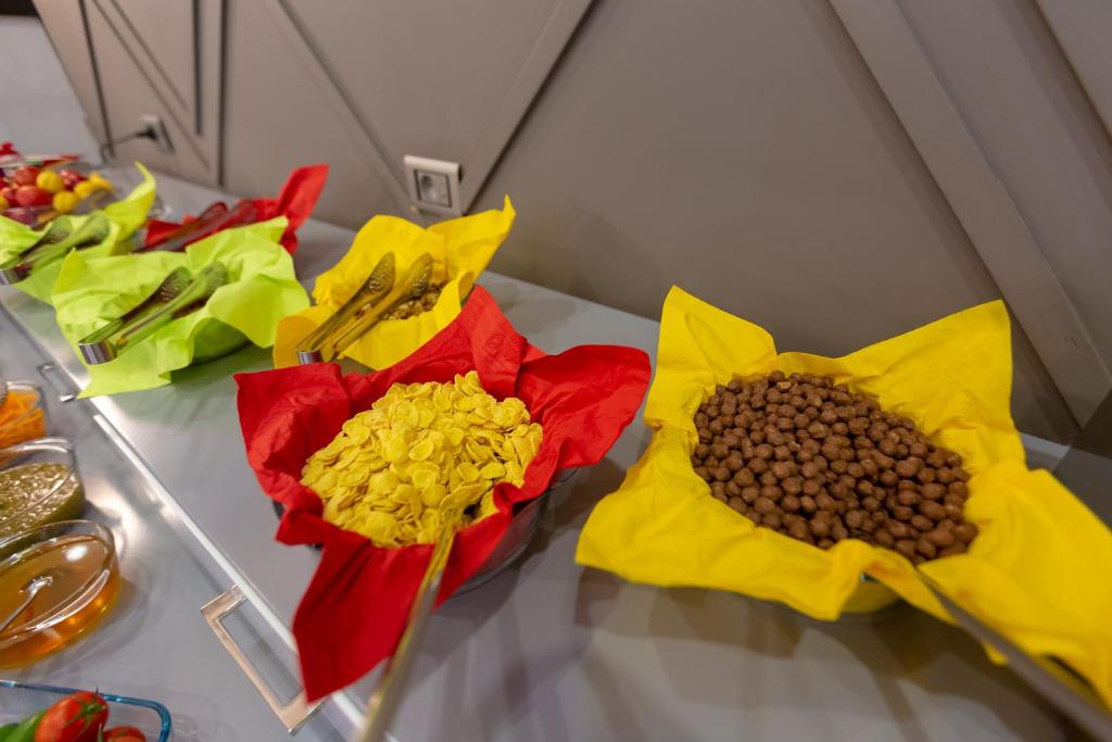 a table topped with yellow and red flowers and beans at Aksent Hotel in Baku